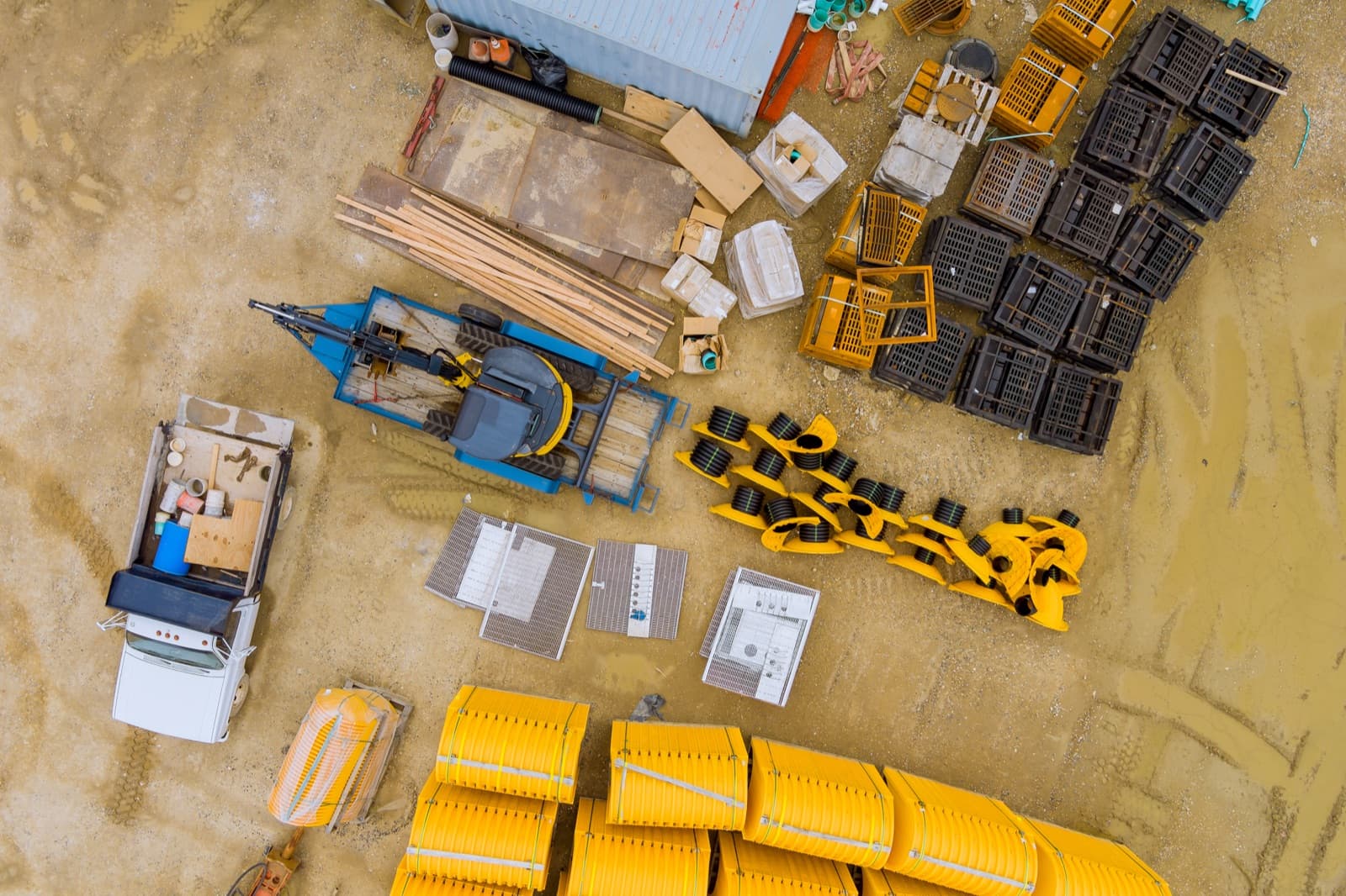 A jobsite laydown yard with pallets of unused material and crated equipment